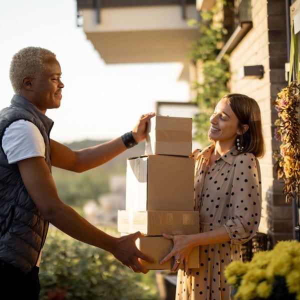 delivery-man-giving-parcels-to-caucasian-woman-2022-01-19-00-01-02-utc